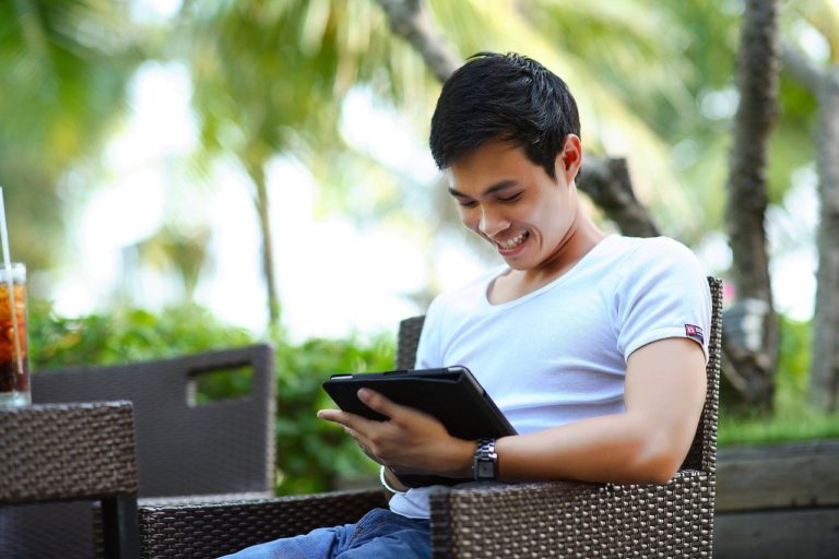 man gambling online on his ipad